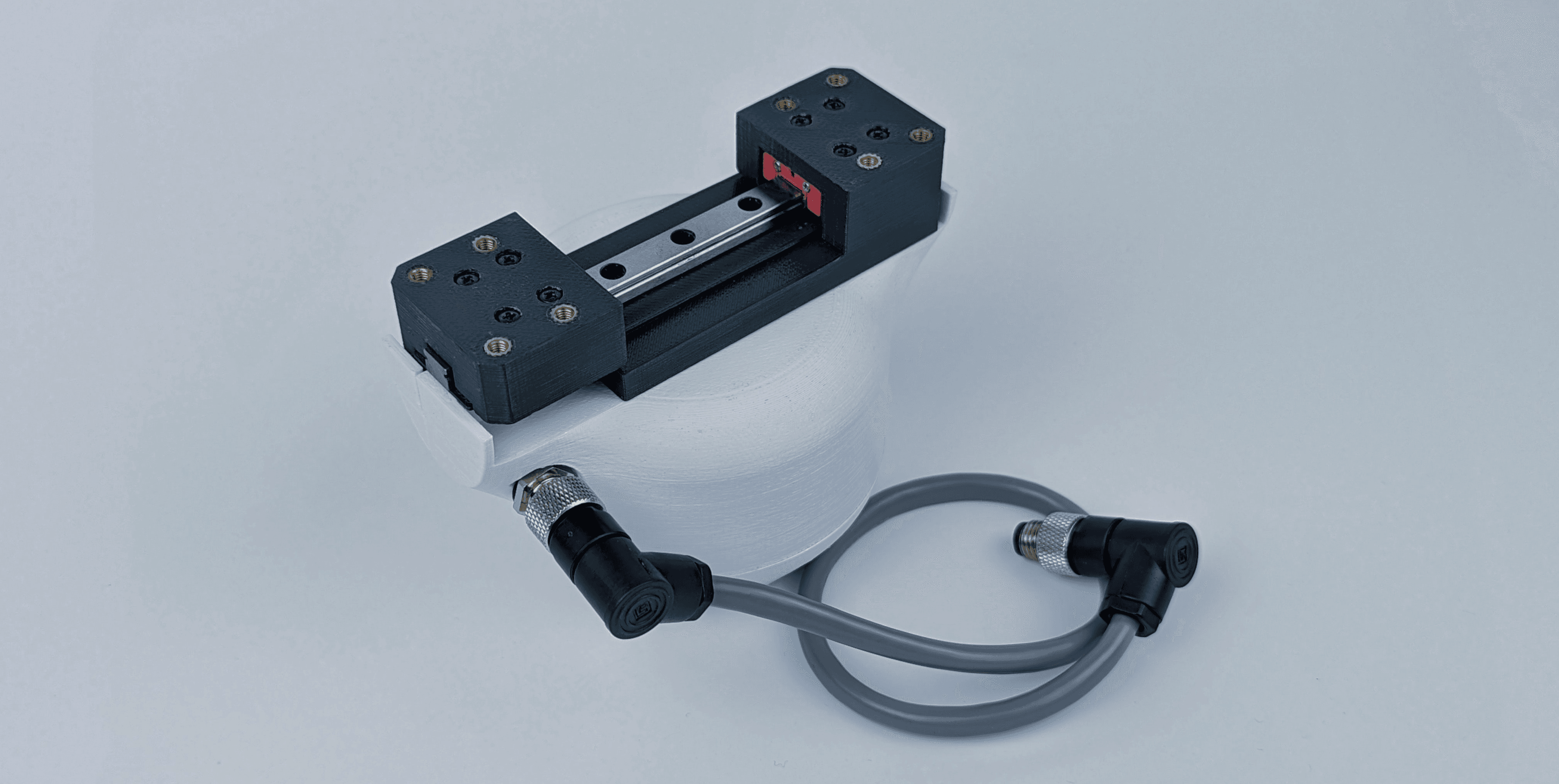 An SSG48 gripper with a cable attached, shown against a light background.