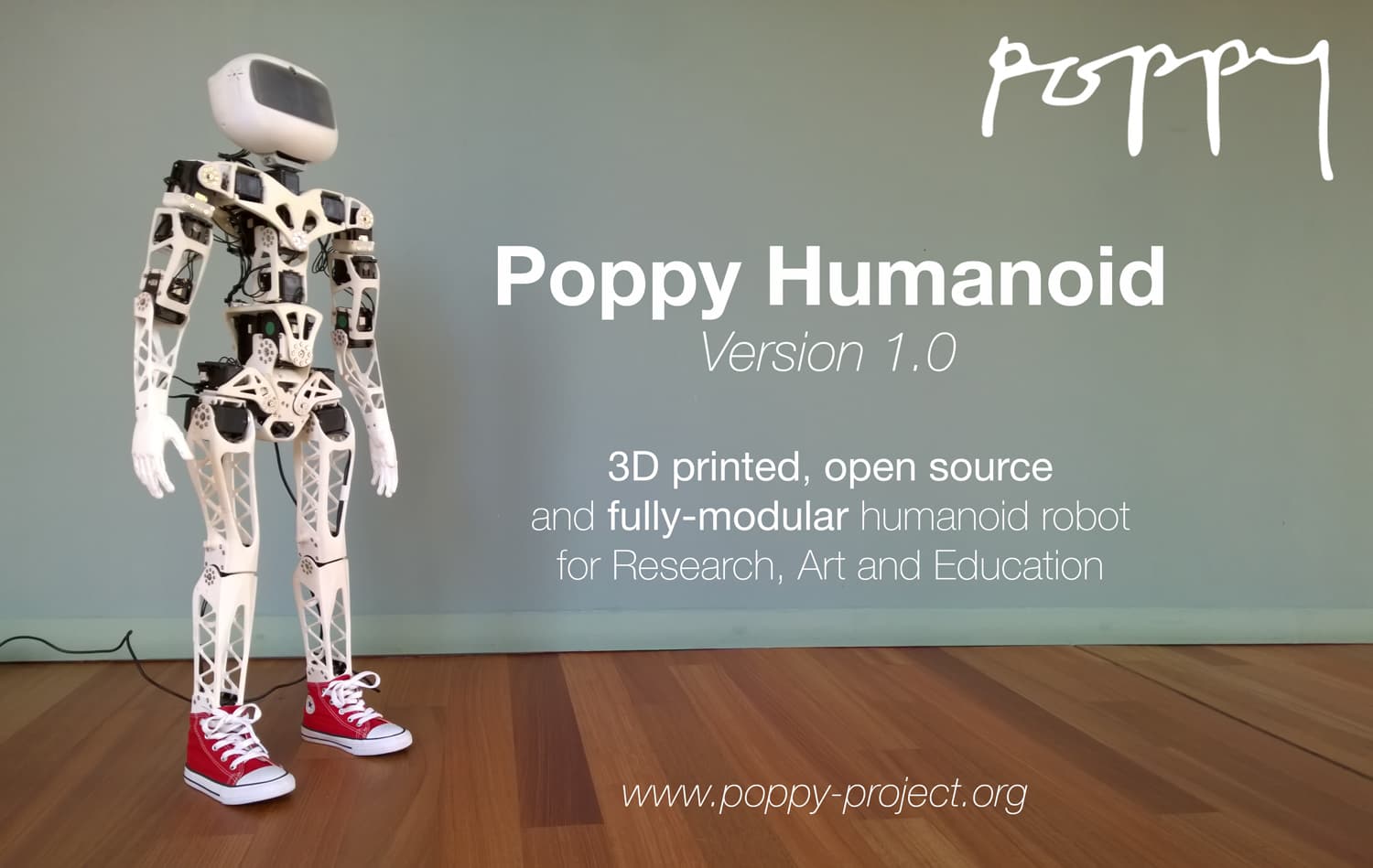 Poppy Humanoid standing on a wooden floor.